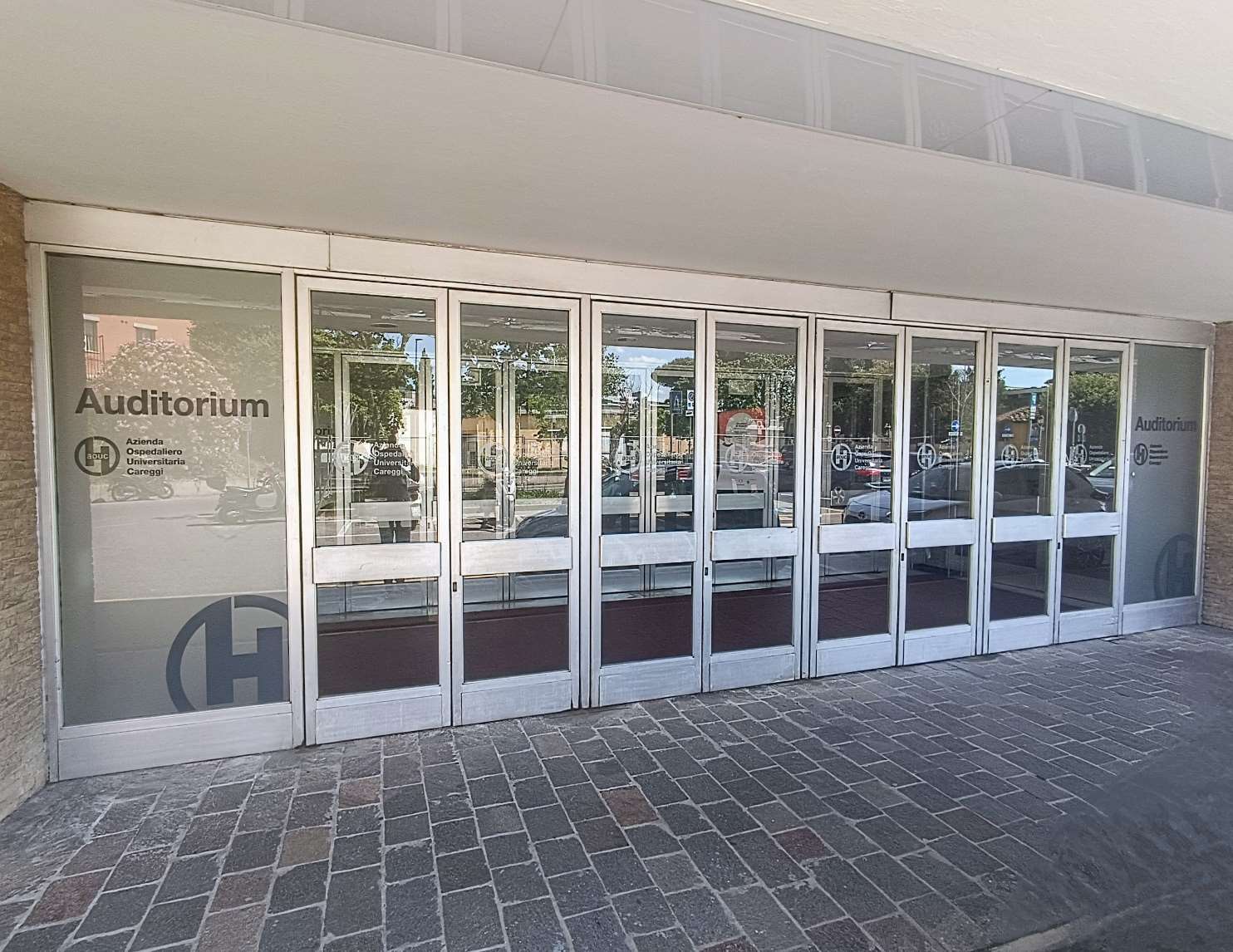 Main glass entrance of the Auditorium CTO on Largo Piero Palagi with branded sliding doors